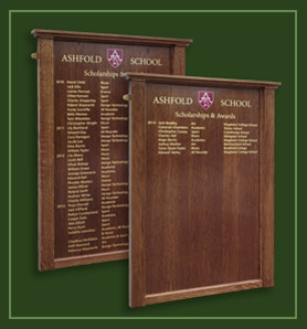 Two wooden honours board showing names of those winning scholarships and wards.