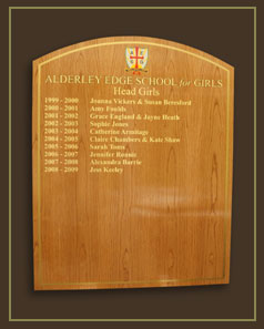 A light golden oak honour board displaying the names of head girls since 1999.