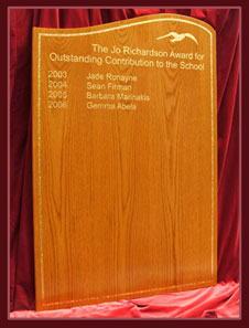 This is a wave shaped honours board in golden oak with gold lettering and seagull logo.