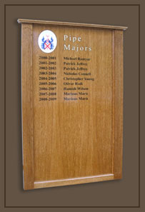 An honour board listing Drum Majors on a solid oak board with fluted columns and ogee capping piece.